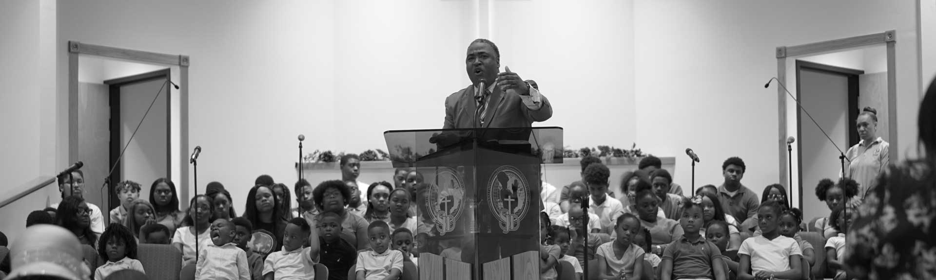 Pastor Marshall preaching What We Believe